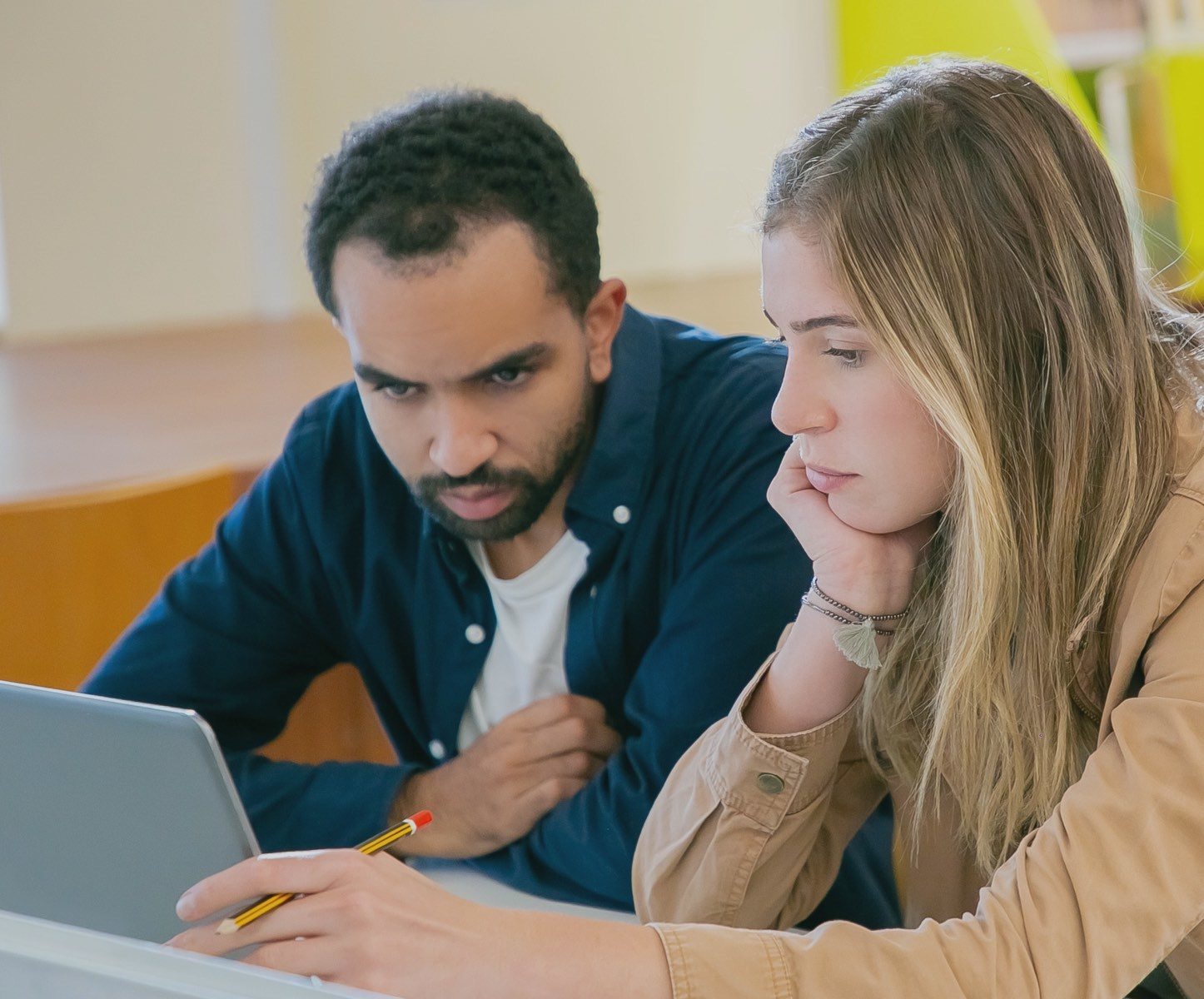 Two apprentices working on document